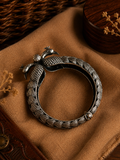 Charulata silver-plated brass bangle with a dual peacock face