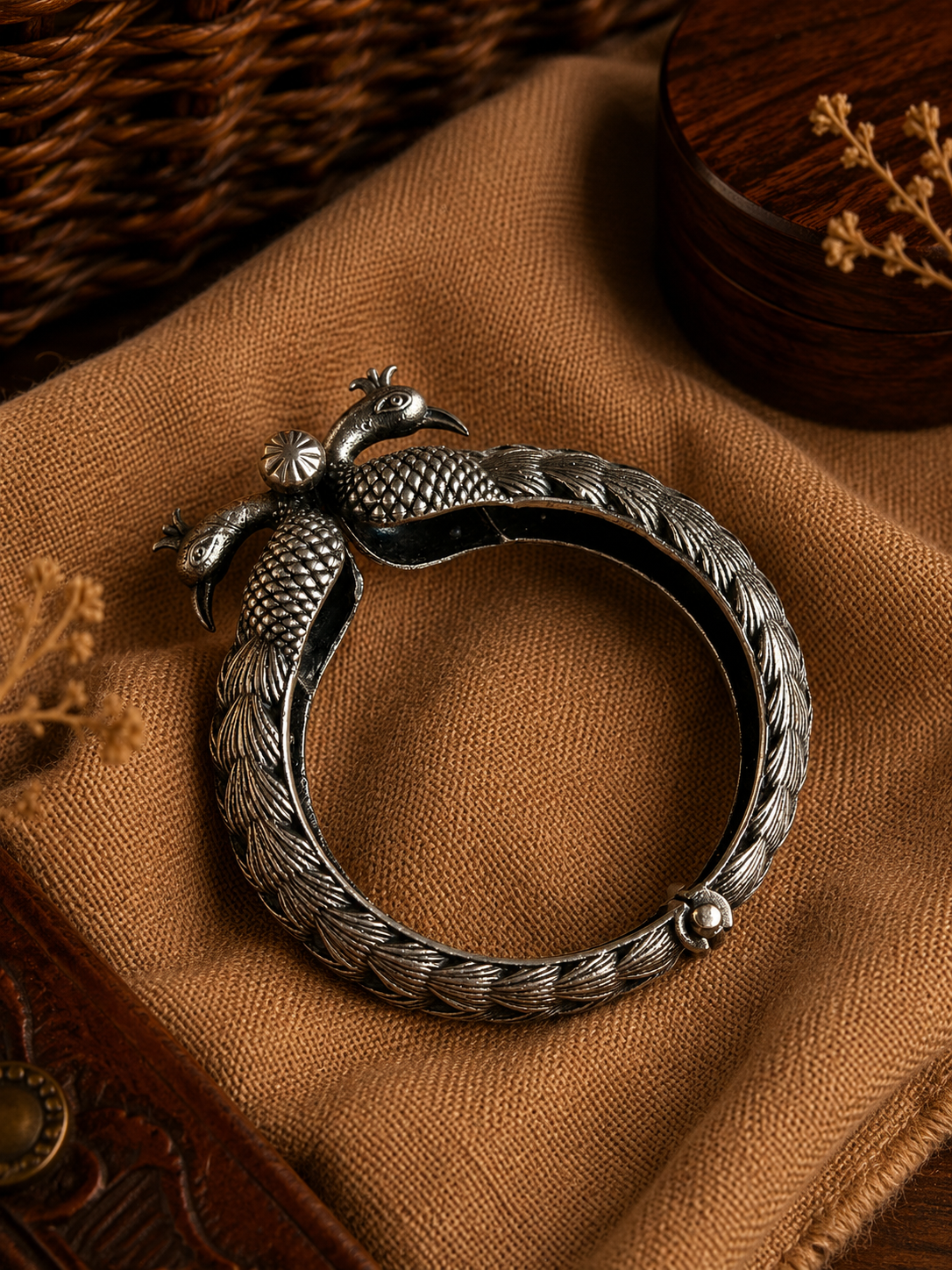 Charulata silver-plated brass bangle with a dual peacock face